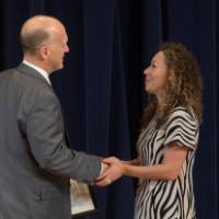 Dean Potteiger shaking hands with a graduate student receiving an award